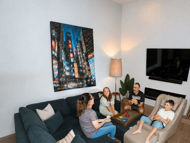 A family in their living room with a child in a Chill-Out Chair